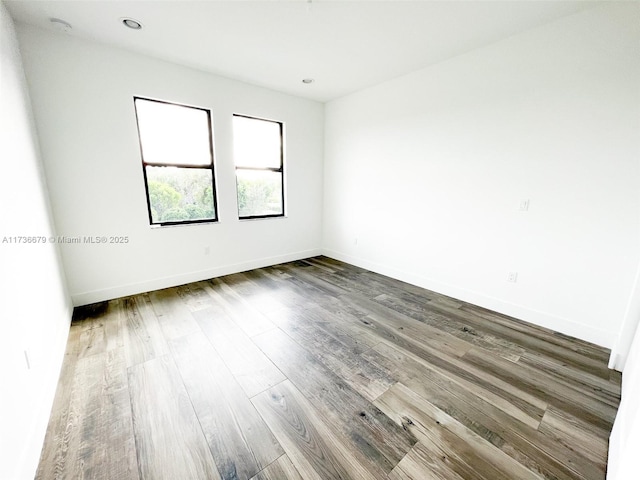 spare room with dark wood-type flooring