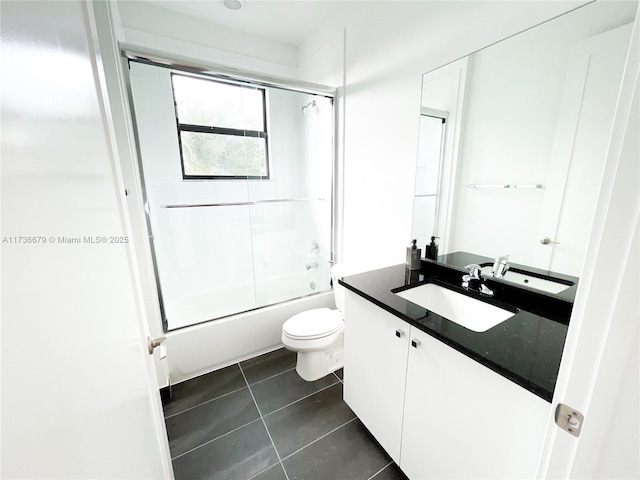 full bathroom with toilet, tile patterned floors, bath / shower combo with glass door, and vanity