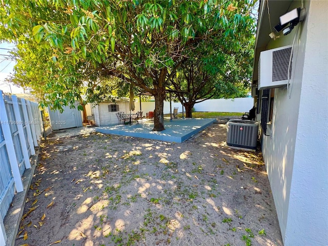 view of yard with cooling unit and a patio area