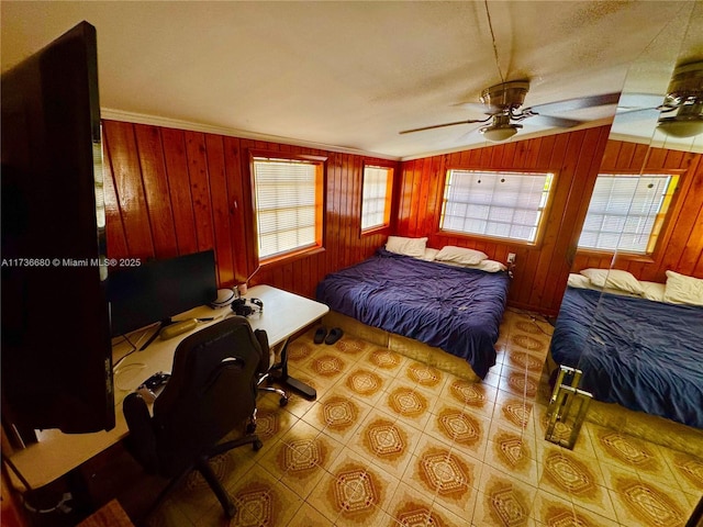 bedroom featuring light tile patterned flooring, wood walls, lofted ceiling, ornamental molding, and ceiling fan