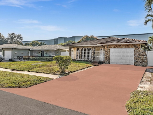 ranch-style home with a garage and a front yard