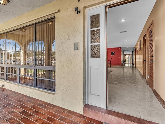 view of exterior entry featuring stucco siding