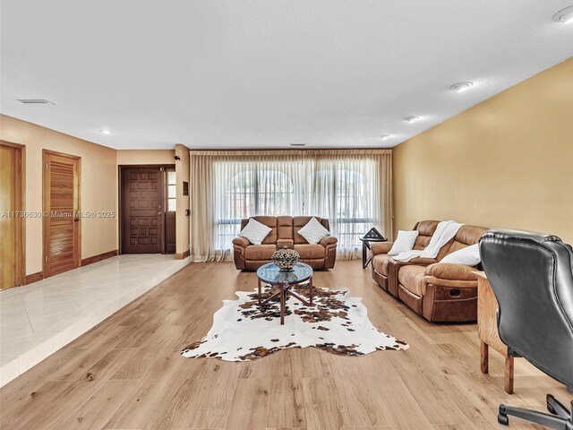 living room featuring light wood-type flooring and baseboards