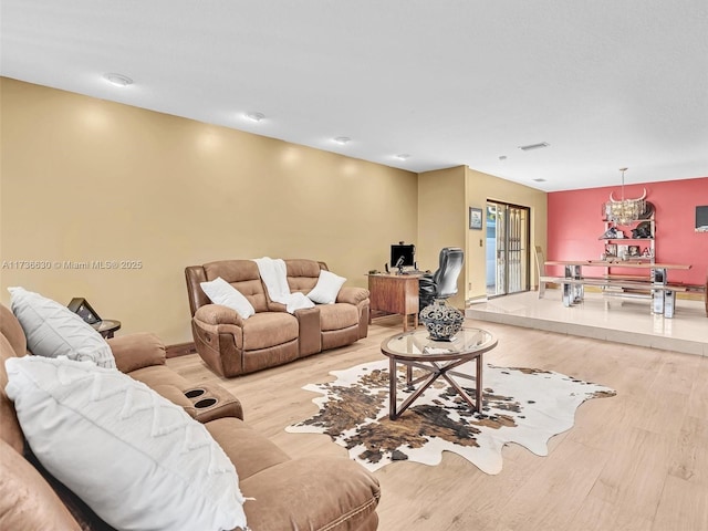 living area with light wood-style flooring and visible vents