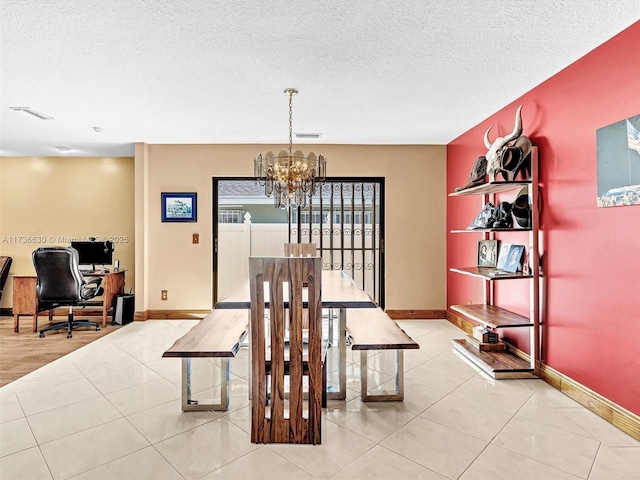 tiled dining area with visible vents, a notable chandelier, a textured ceiling, and baseboards