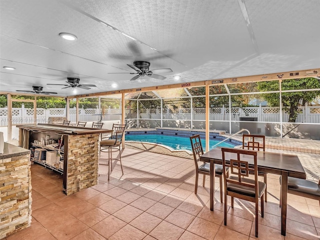 view of pool featuring glass enclosure, a patio, and a fenced backyard