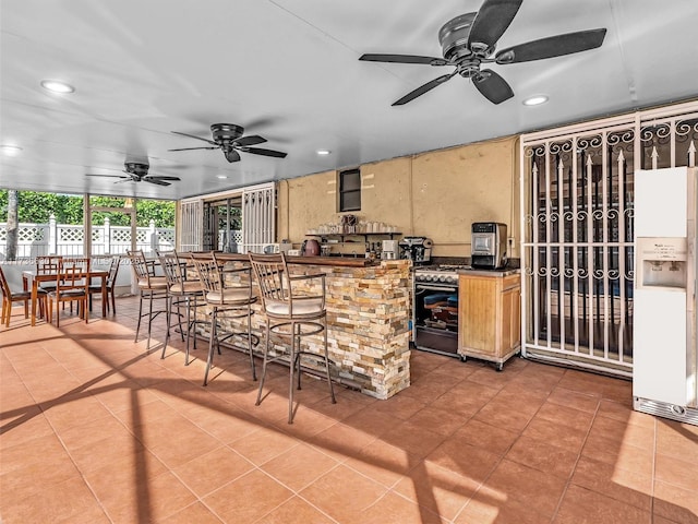 kitchen featuring dark countertops, tile patterned floors, and recessed lighting