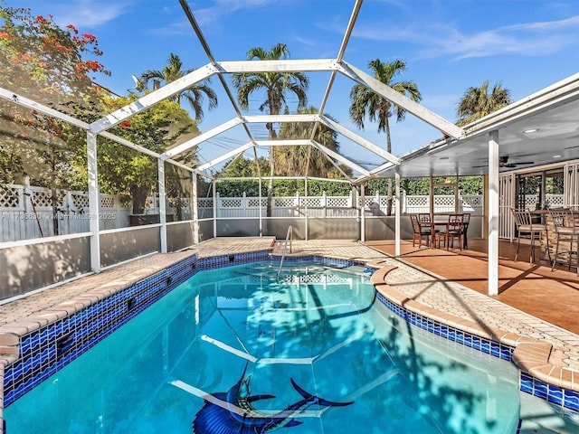 view of pool with a fenced in pool, a patio, glass enclosure, ceiling fan, and fence private yard