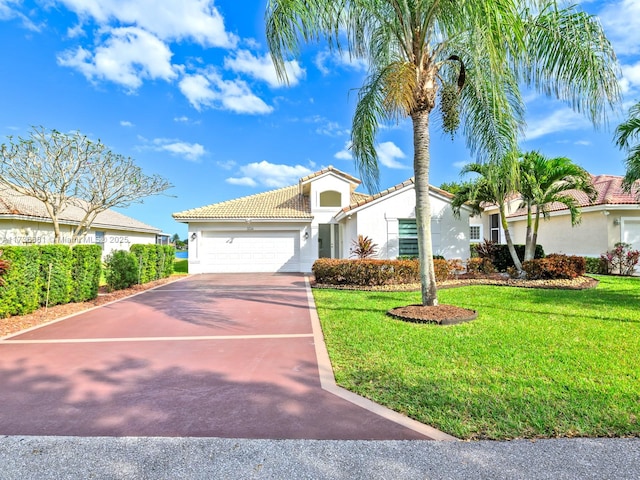 mediterranean / spanish house with a garage and a front yard