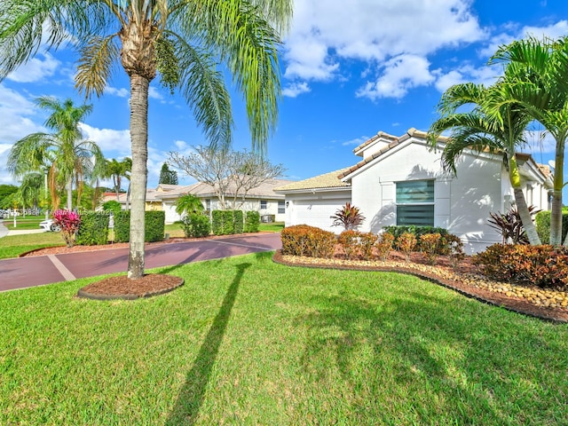 view of front of home featuring a garage and a front yard