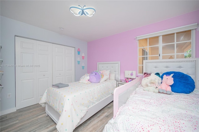 bedroom with light wood-type flooring and a closet