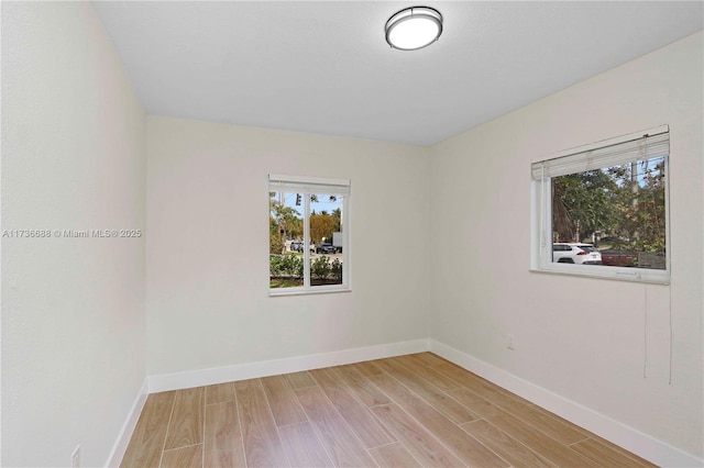 spare room featuring light wood-type flooring