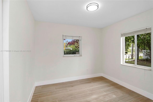 unfurnished room with light wood-type flooring