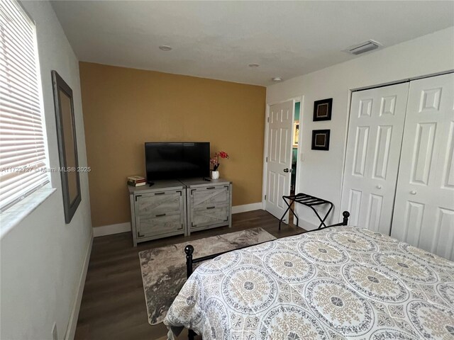 bedroom with dark wood-type flooring