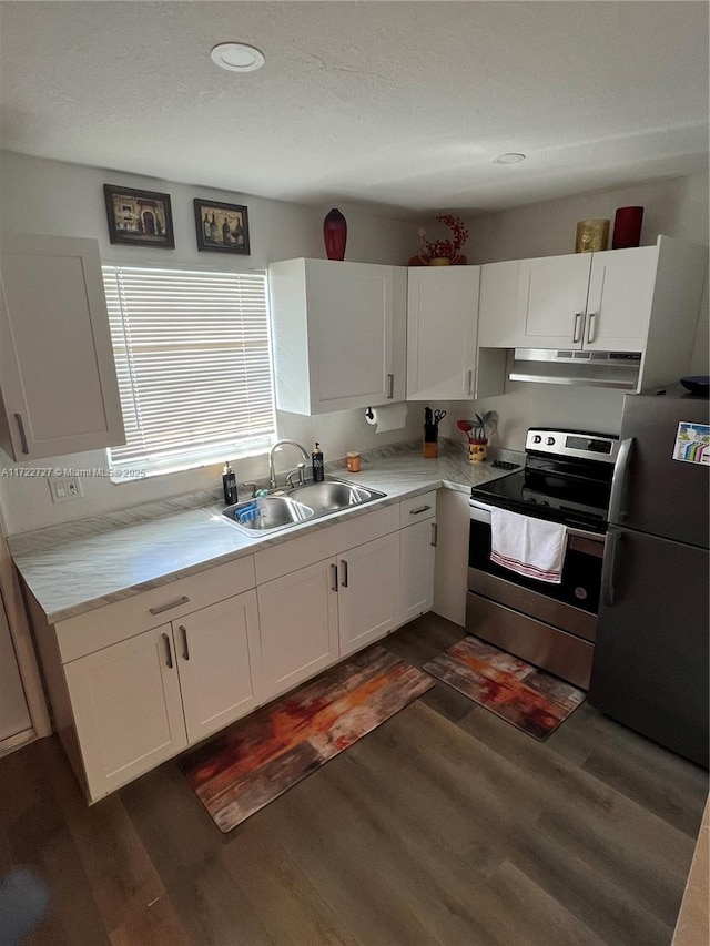 kitchen with stainless steel appliances, sink, white cabinets, and dark hardwood / wood-style flooring