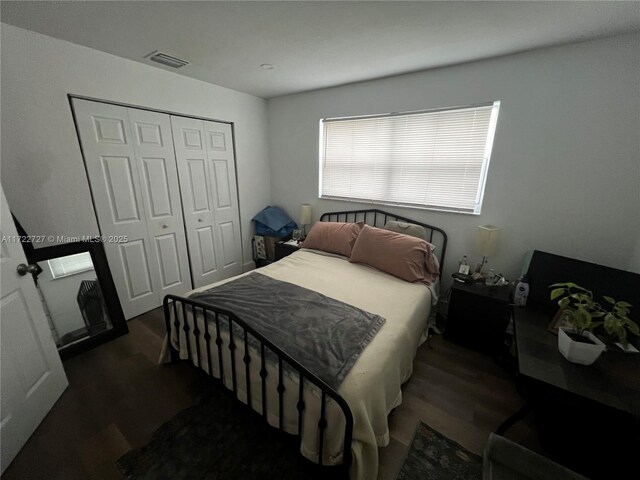 bedroom with dark hardwood / wood-style floors