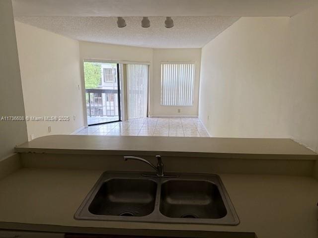 kitchen with sink and a textured ceiling