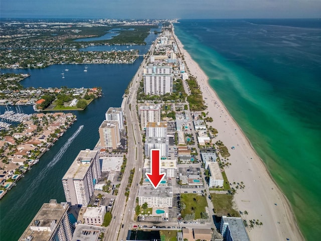 drone / aerial view featuring a water view and a view of the beach