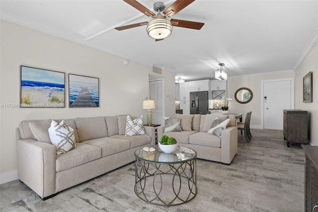 living room featuring crown molding, ceiling fan, and light hardwood / wood-style flooring