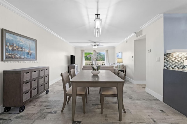 dining room featuring crown molding, ceiling fan, and light wood-type flooring