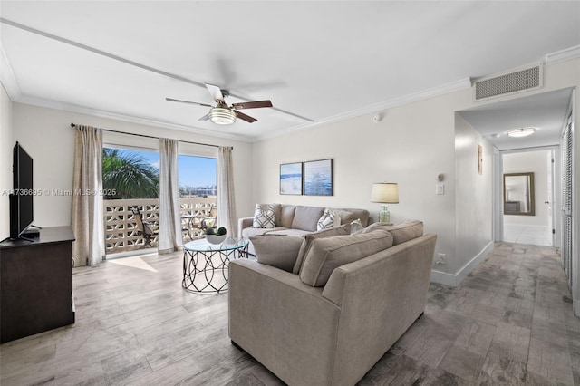 living room featuring hardwood / wood-style flooring, ornamental molding, and ceiling fan