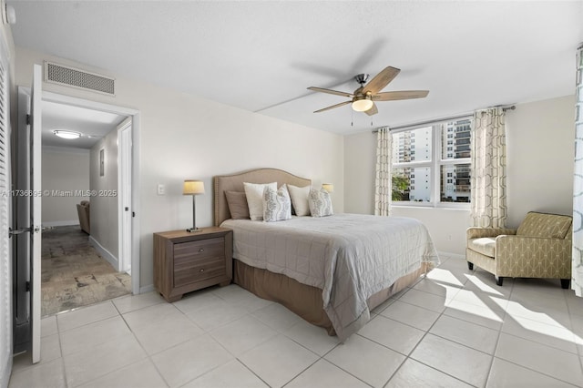 bedroom featuring light tile patterned floors and ceiling fan