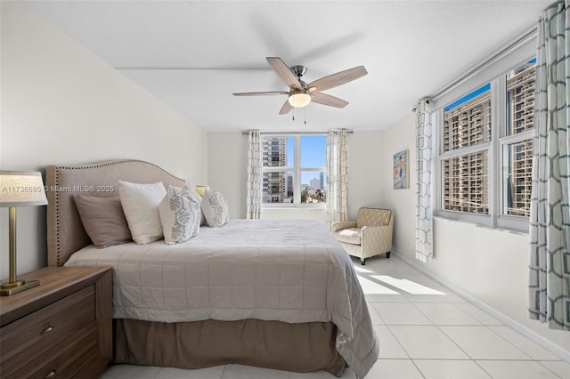 bedroom with light tile patterned floors and ceiling fan