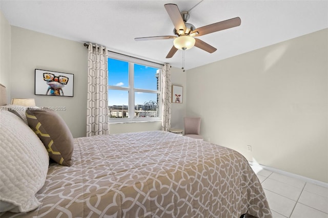 tiled bedroom featuring ceiling fan