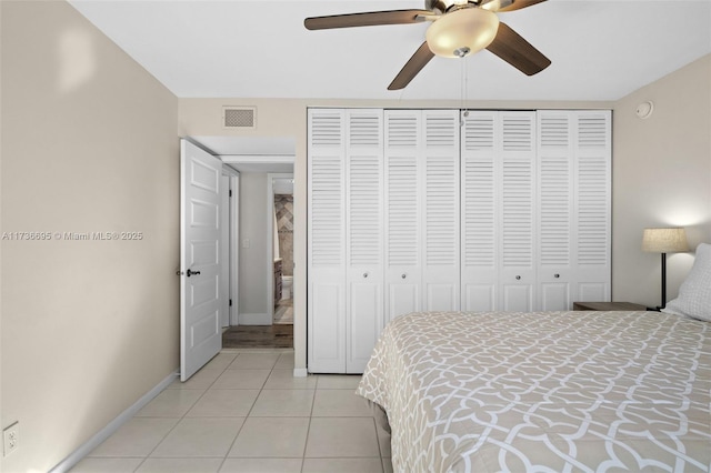 tiled bedroom with a closet and ceiling fan