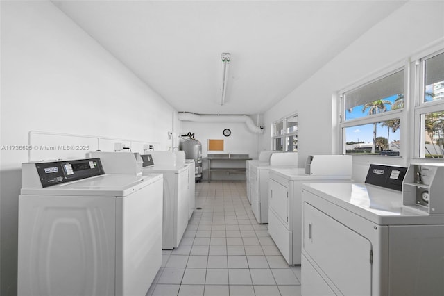 washroom featuring washer and dryer and light tile patterned floors