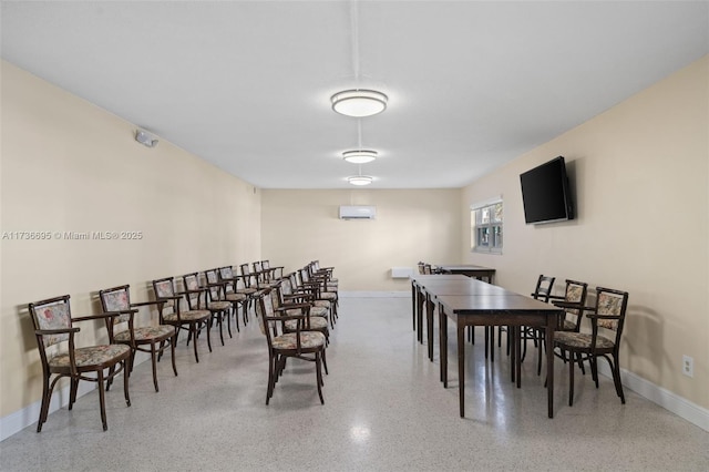 dining room featuring a wall unit AC