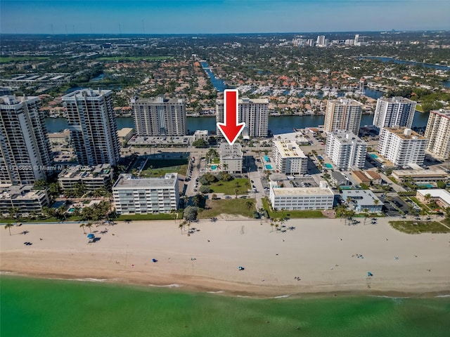 drone / aerial view with a water view and a view of the beach