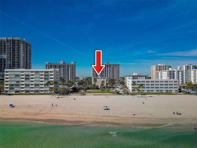 aerial view featuring a view of the beach and a water view