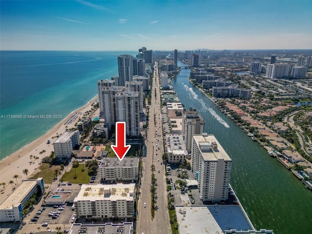 drone / aerial view featuring a water view and a beach view