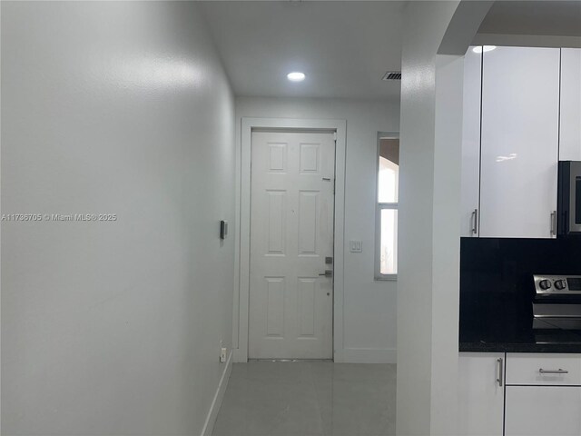 hall with sink and light tile patterned floors