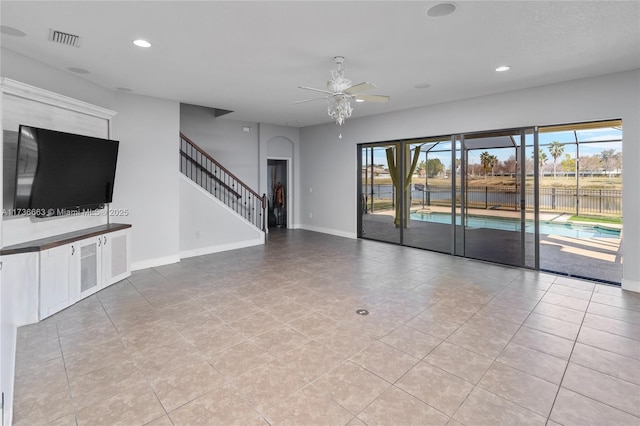 unfurnished living room with ceiling fan