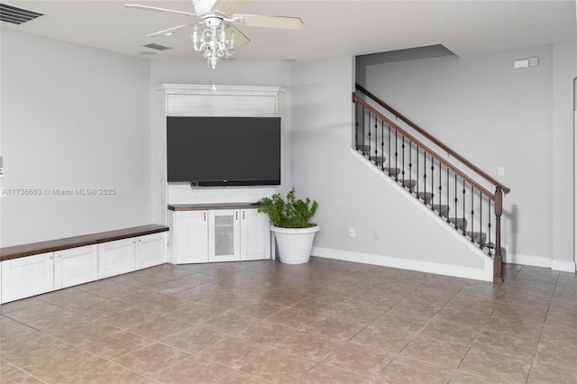 unfurnished living room featuring ceiling fan