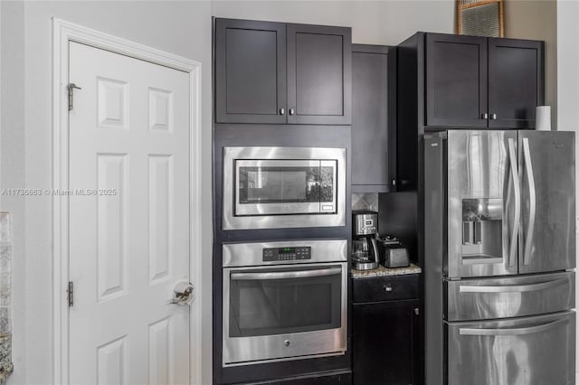 kitchen with stainless steel appliances and light stone countertops