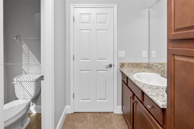 bathroom featuring vanity, toilet, and tile patterned flooring