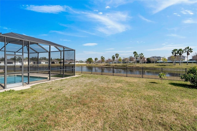 view of yard with a fenced in pool, a lanai, and a water view