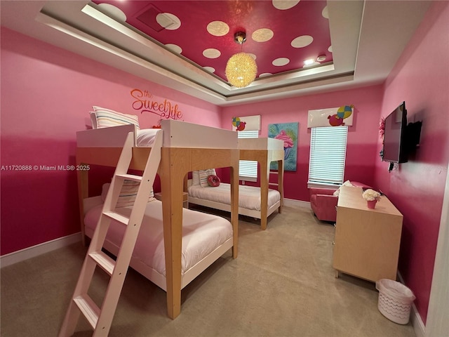 bedroom with a tray ceiling and carpet flooring