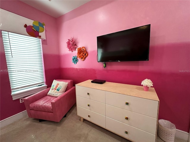 living area featuring light carpet