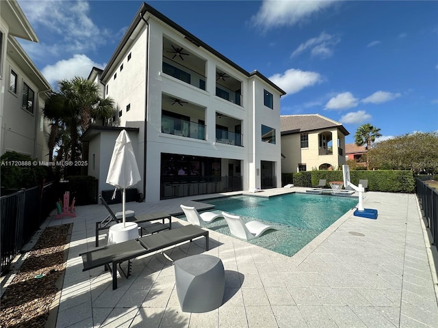 view of pool with a patio and ceiling fan