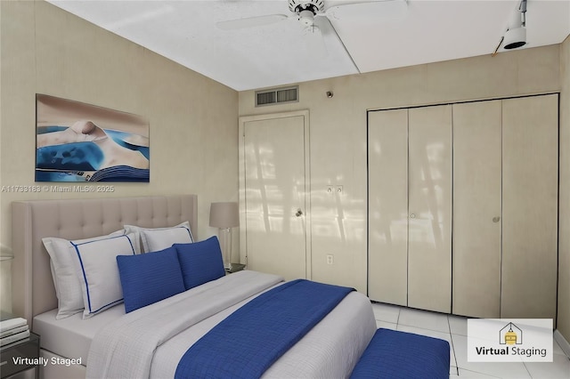 bedroom with a closet, ceiling fan, and light tile patterned flooring