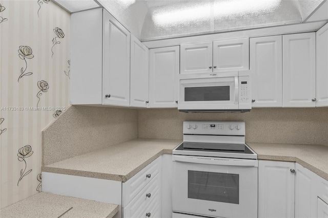 kitchen with white cabinetry and white appliances