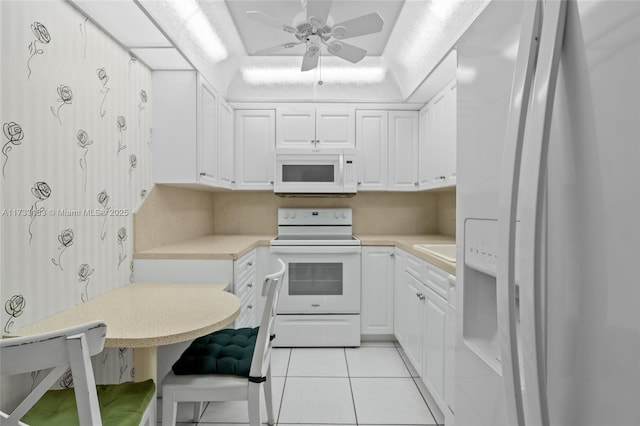 kitchen featuring white cabinetry, light tile patterned floors, white appliances, and ceiling fan