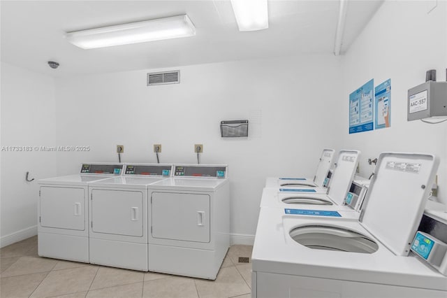 1200 Saint Charles Pl Unit Ph7, Pembroke Pines, FL 33026 - communal laundry room with washing machine and dryer, light tile patterned floors, and baseboards