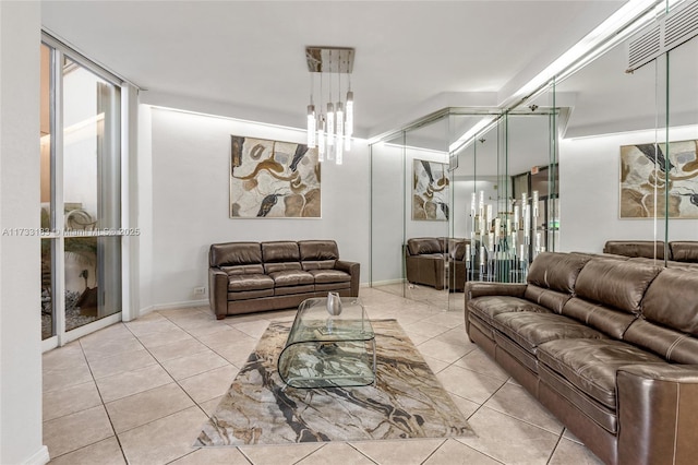 living room with light tile patterned floors and an inviting chandelier