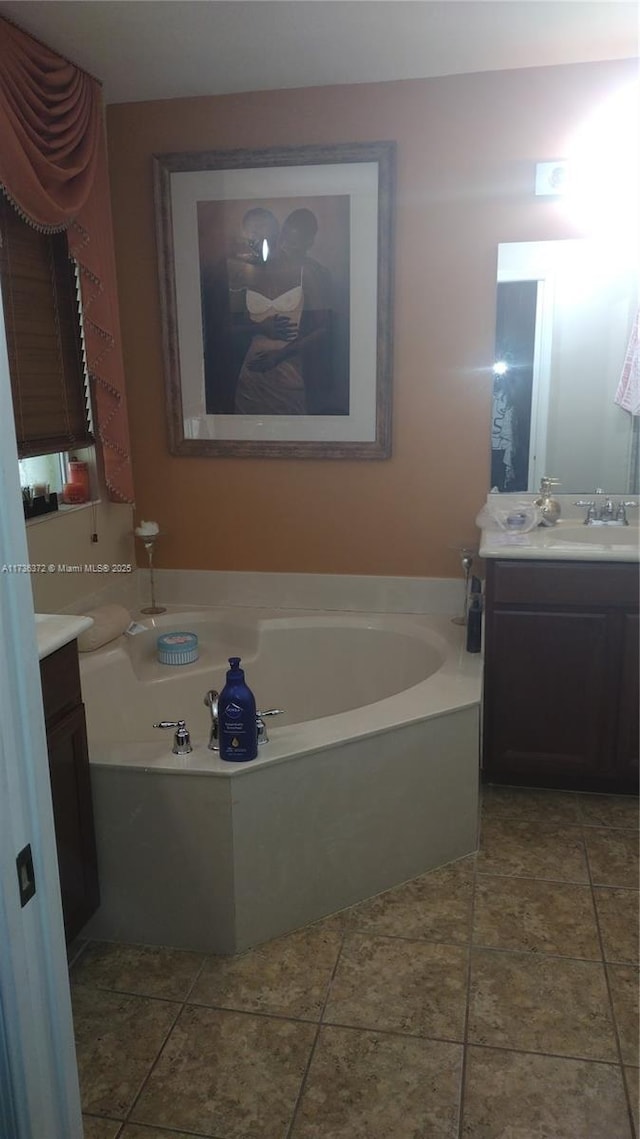 bathroom featuring vanity, a bath, and tile patterned flooring