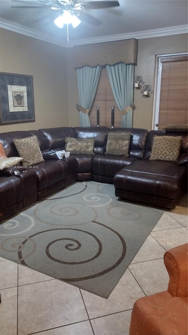 living room featuring ceiling fan, ornamental molding, and light tile patterned floors